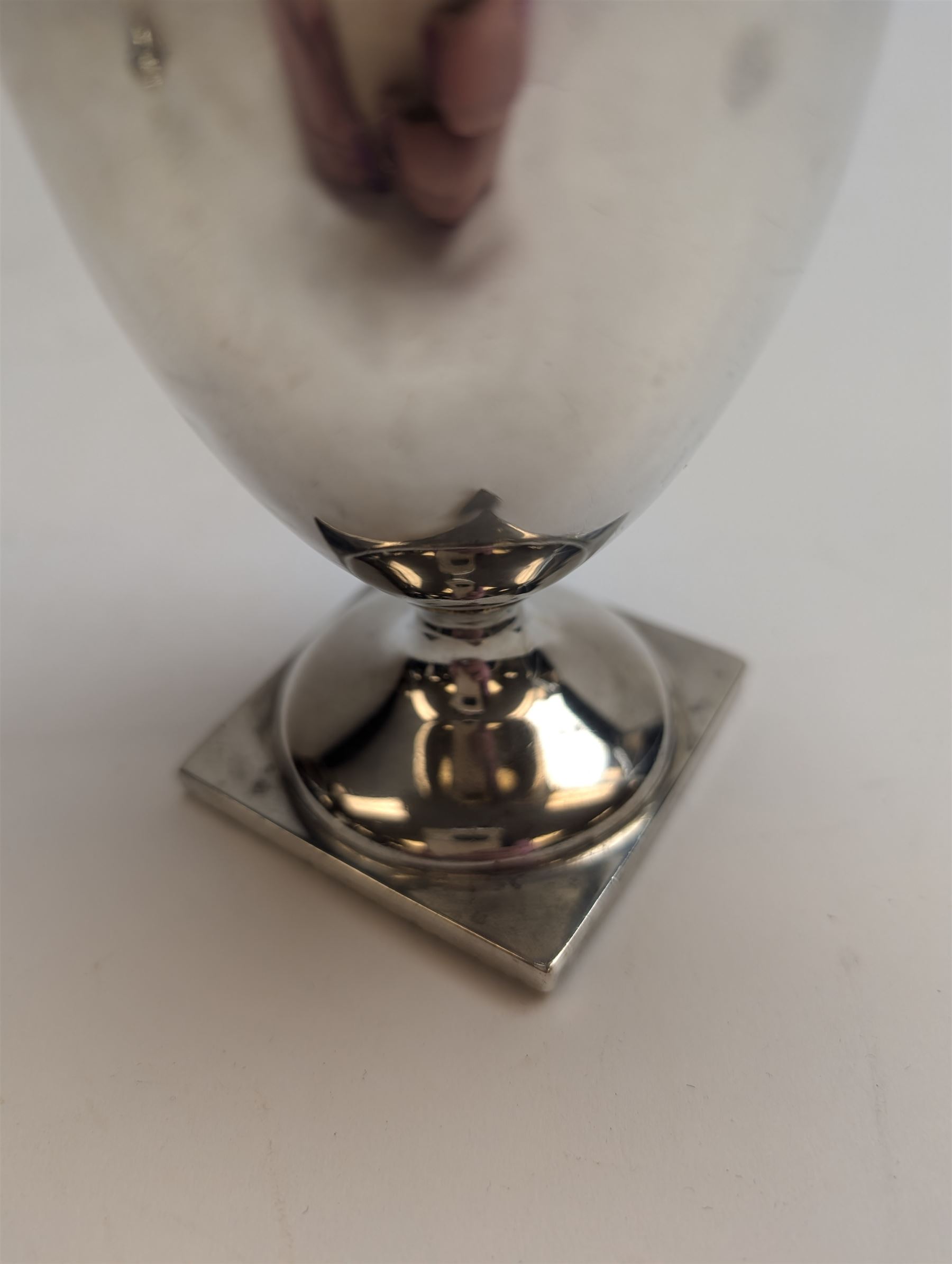 1920s silver cream jug, of helmet form with loop handle and upon a square base, hallmarked Charles Edwards, London 1926, including handle H15cm