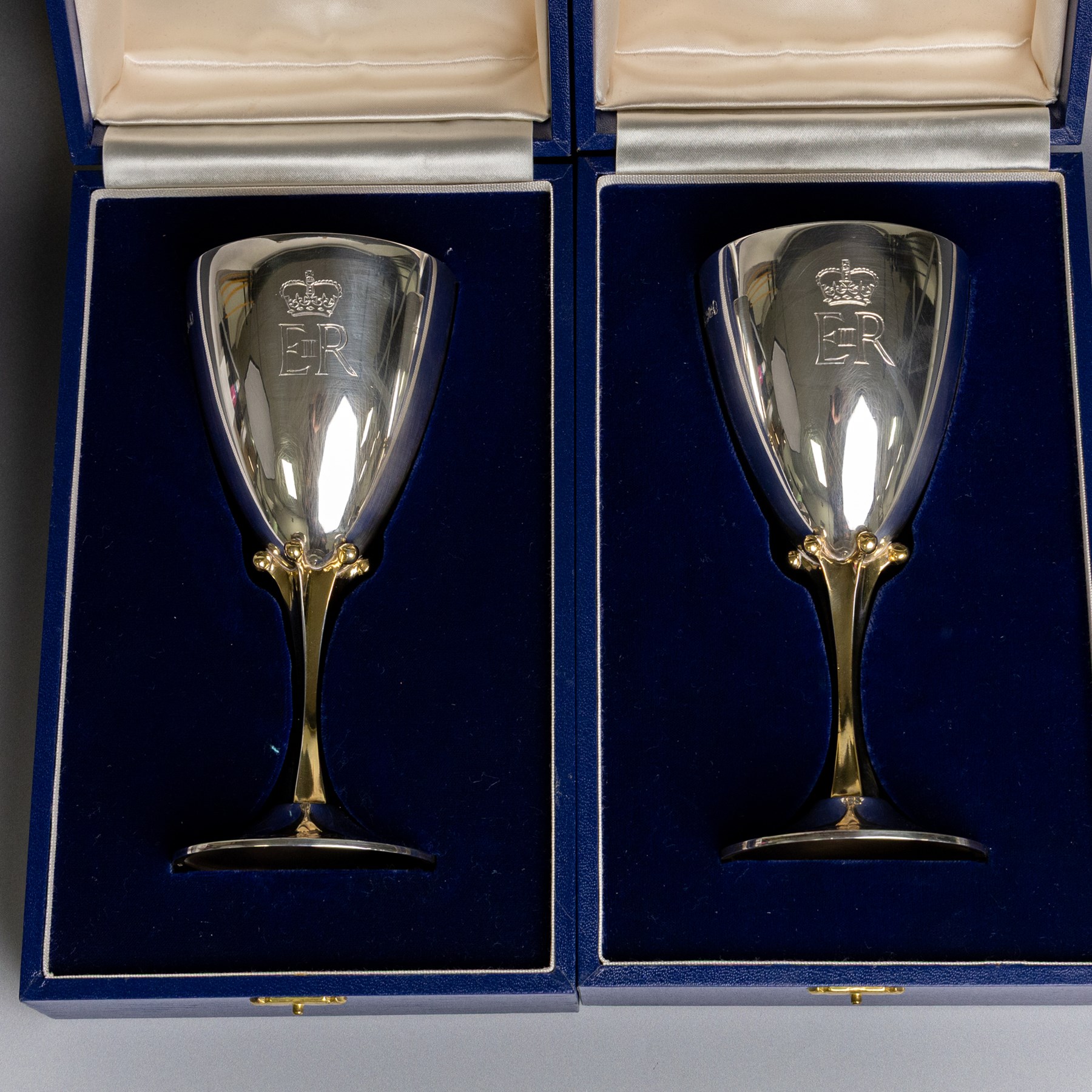 Pair of limited edition commemorative silver goblets, each engraved with HRH Queen Elizabeth's Royal cypher, the bowls with gilt interior and upon a parcel gilt stem, the circular foot engraved 'The Queen's Silver Jubilee 1952-1977', both hallmarked Mappin & Webb Ltd, Sheffield 1977, limited edition numbers 267 & 268/2500, boxed, H17cm