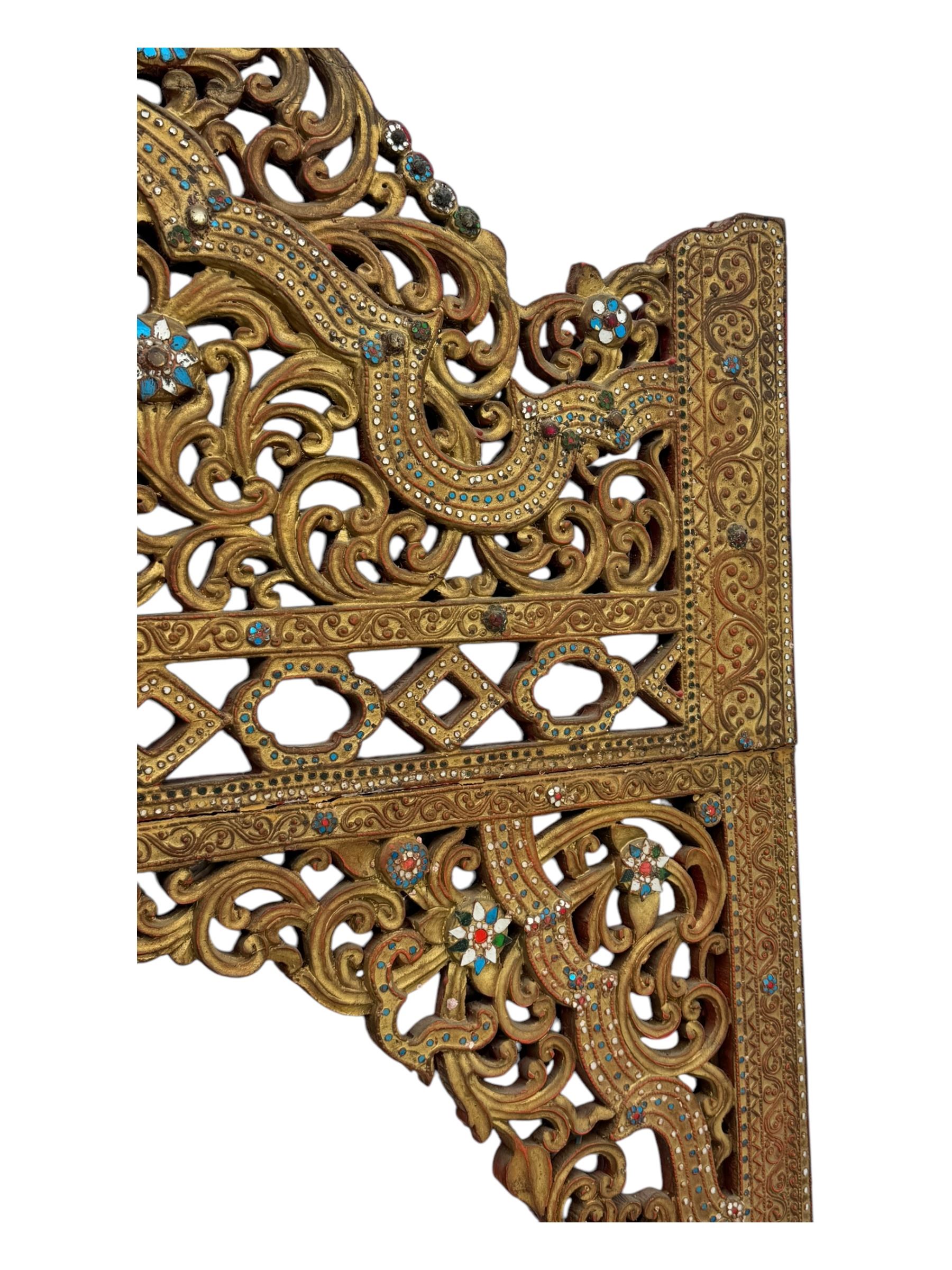Large North African design carved and painted wall mirror, decorated with floral motifs, pierced foliate scrolls, inset mirrored panels, and colourful painted detailing, enclosing an oval bevelled mirror plate