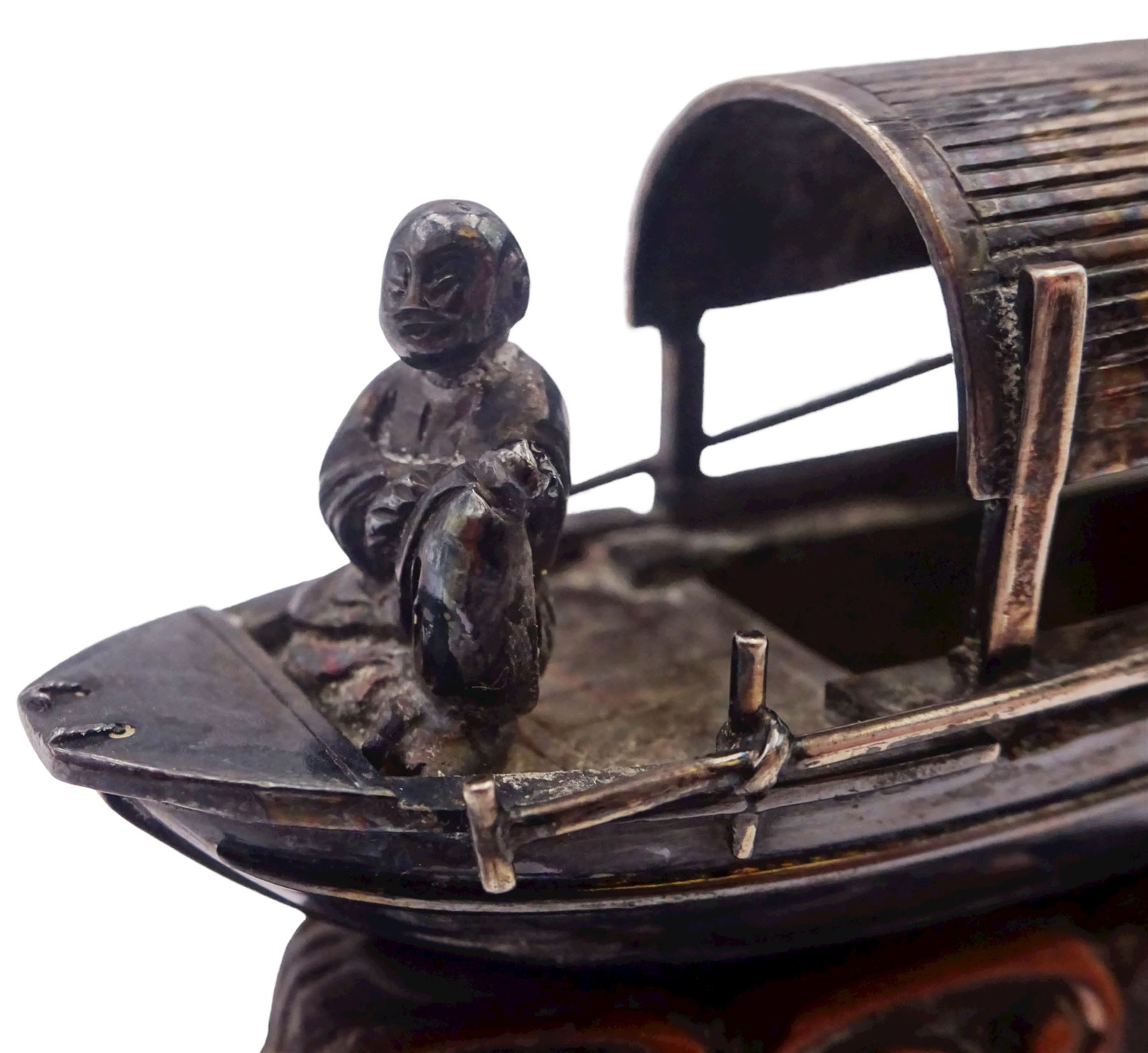 Chinese miniature silver model of a junk, with character mark to stern, mounted upon a carved wooden stand, overall H5cm L6.5cm