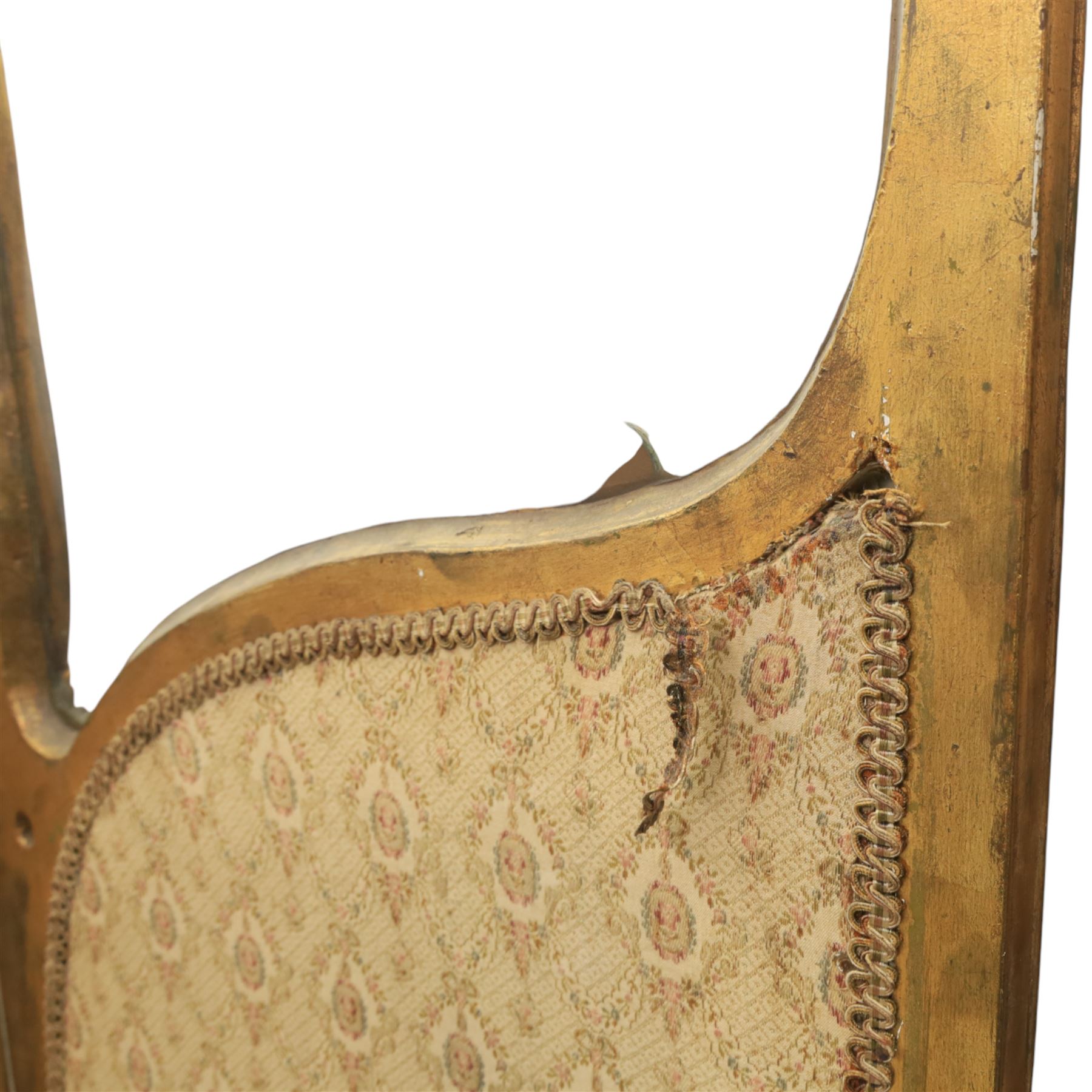 Rococo style giltwood three-panel dressing screen, each panel with shaped and scroll carved frame decorated with shell and foliate motifs, the upper sections glazed, the lower sections upholstered in patterned fabric, hinged to form a folding screen