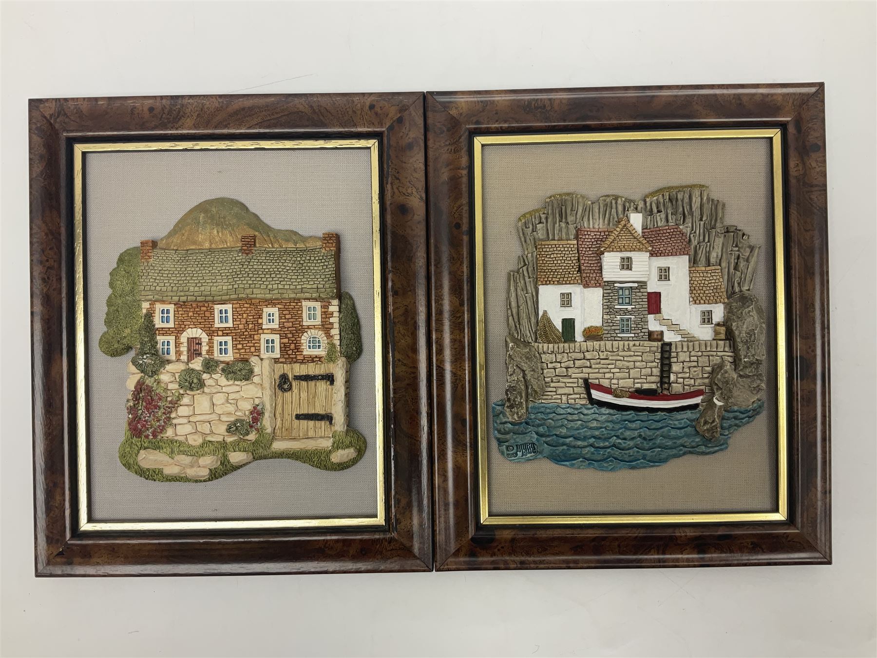 Nine Lilliput Lane framed wall plaques, including Fell View, Battleview, Catslide Cottage, Ashdown Hall and Shannon's Bank, together with three smaller circular framed Lilliput Lane plaques
