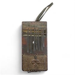 Australian Aboriginal boomerang decorated with eucalyptus leaves, a plain boomerang,  African wood and iron lamellophone and a carved wood tablet with two figures