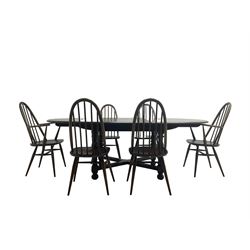 Ercol - 'Old Colonial' 705 elm extending dining table, oval top with hidden leaf, raised on turned supports united by X-stretcher (W163cm D108cm H72cm); and Ercol - set six  (4+2) dark elm 'Quaker Back Windsor Dining Chairs', hoop and stick backs 