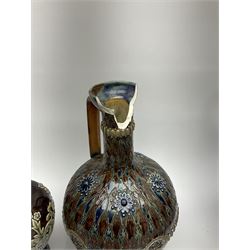 A collection of Doulton Lambeth, to include a jug with silver mounted rim, H18cm, a jug with relief flower head decoration upon a mottled blue ground, H24cm, a jardinaire with repeated foliate decoration, etc., each with impressed marks beneath. 
