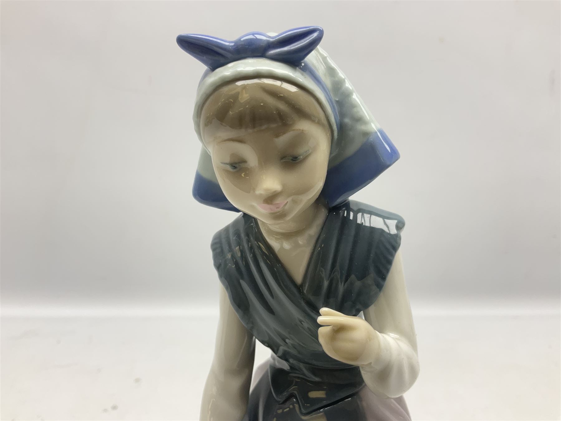 Three Lladro figures, comprising Dutch Girl with Braids no 5063, Dutch Girl with Duck no 5066 and Aracely with Ducks, all with original boxes, largest example H25cm