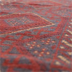 Afghan hand-knotted wool runner, dark red and indigo blue madder, with a repeating central diamond medallion design within multiple geometric borders, with flatweave ends 