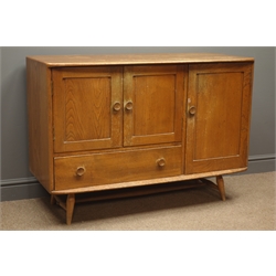  Mid 20th century Ercol elm and beech sideboard, two cupboard doors enclosing an adjustable shelf, above a deep drawer, vertical cupboard to the side with a removable cutlery rack, turned supports and stretchers, W115cm, H82cm, D52cm  