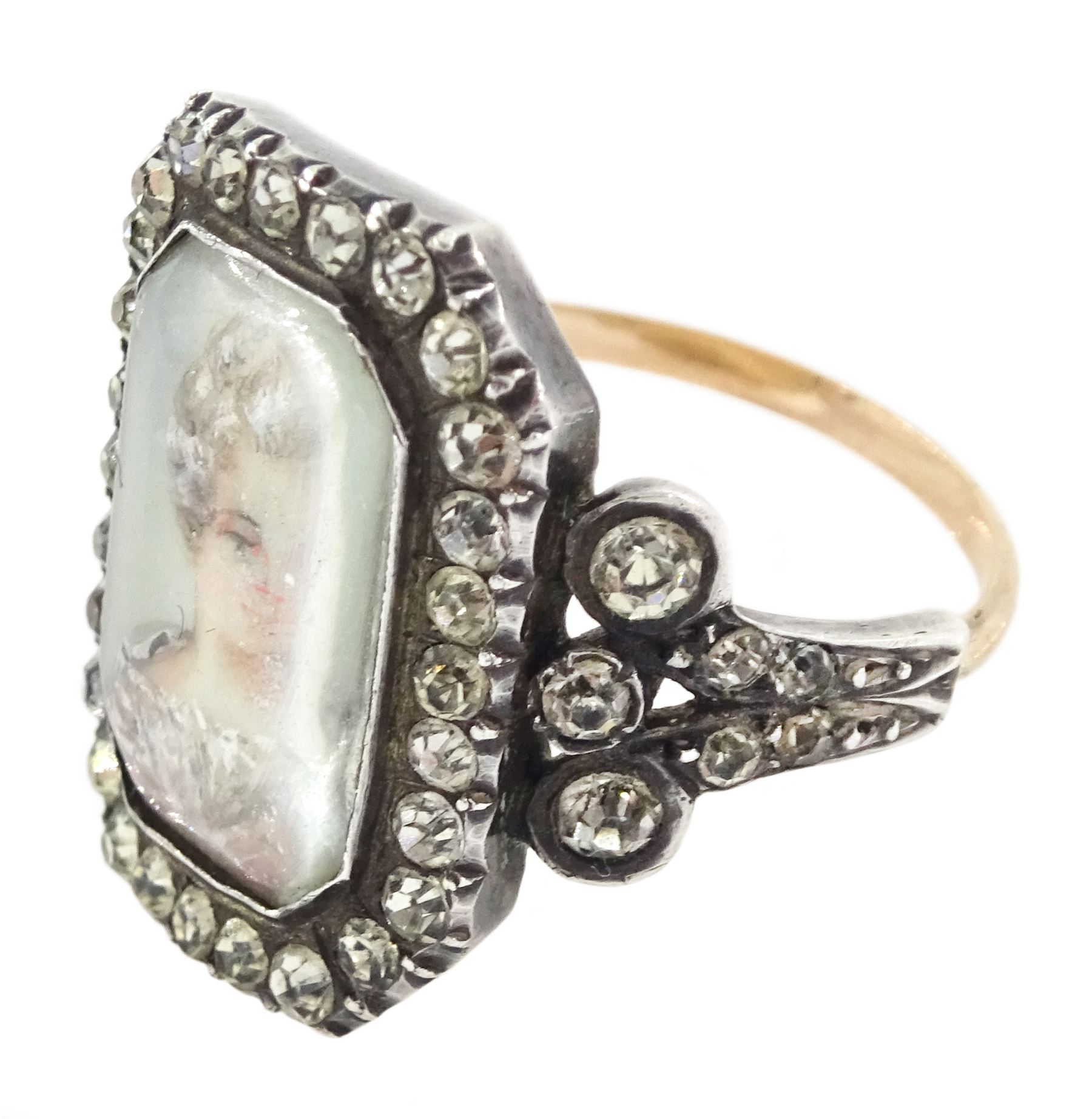 19th century 18ct gold and silver paste set portrait ring, octagonal miniature of a woman on ivory, under a glazed panel, with paste stone surround, to bifurcated paste set shoulders. This lot has been registered for sale under Section 10 of the APHA Ivory Act