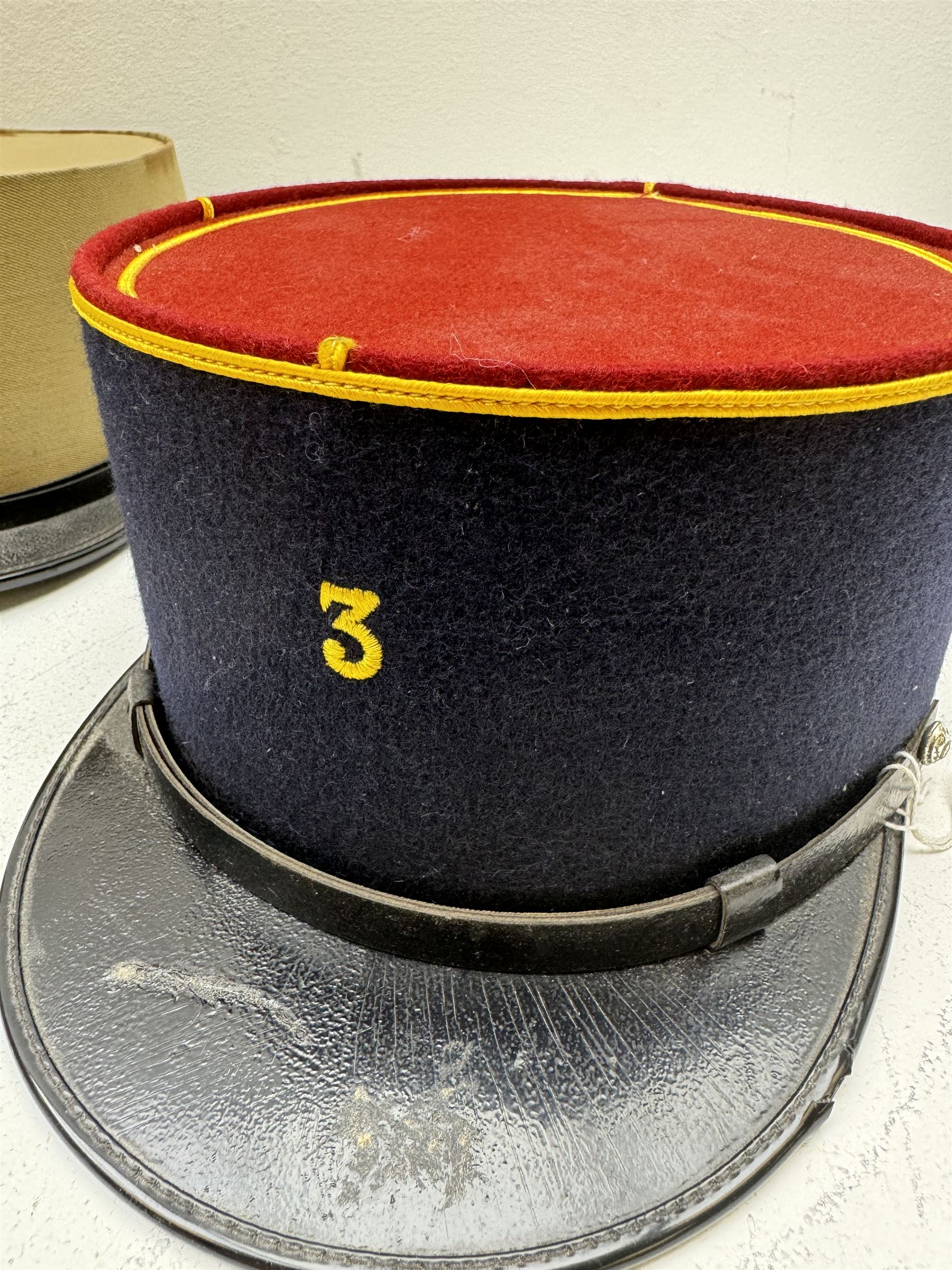 Three French Foreign Legion Kepis; two infantry examples and the third Calvary, each with black peak, original leather sweatband and markers mark stamped inside 