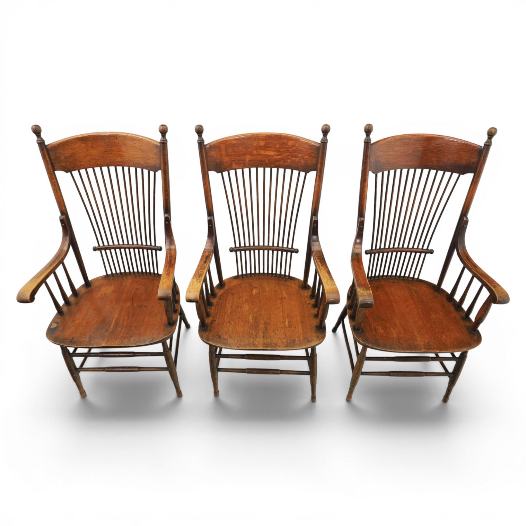 Set of three 19th century ash and elm spindle back Windsor armchairs, arched top rails above fan-shaped spindle backs, curved arms with turned supports, shaped saddle seats, on turned legs joined by H-stretchers