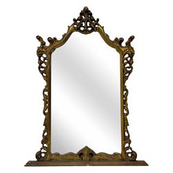Victorian design gilt framed overmantel mirror, the arched and moulded frame adorned with scrolling foliate motifs and acanthus leaves, surmounted by a pierced cartouche, plain mirror plate, resting on a shaped base