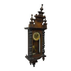 German regulator style wall clock c1900, with an eight-day spring driven movement striking the hours and half hours on a coiled gong, with a fully glazed door with flanking turned columns, decoratively carved pediment with finials, visible pendulum with beat plate.