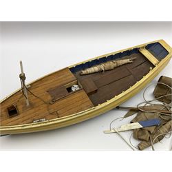 Early 20th century cream and blue painted wooden model of a Whitby coble, the planked upper deck with access hatch to a fitted motor, simulated planked mahogany lower deck with inspection hatch for propeller shaft, various masts and sails and detachable external rudder L70cm. Auctioneer's note: From the Walker family of Sandsend