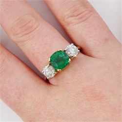 Platinum emerald and diamond three stone ring, single cushion cut emerald of approx  1.85 carat, set with a single round brilliant cut diamond either side, hallmarked, total diamond weight approx 1.20 carat