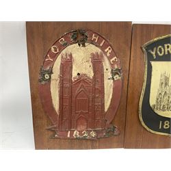 Four fire mark insurance plaques mounted on boards to include three Yorkshire examples and another depicting a raised phoenix amidst flames, one with label verso stating 'Removed From Bilton Haggs Old Farm House 1966', L30cm