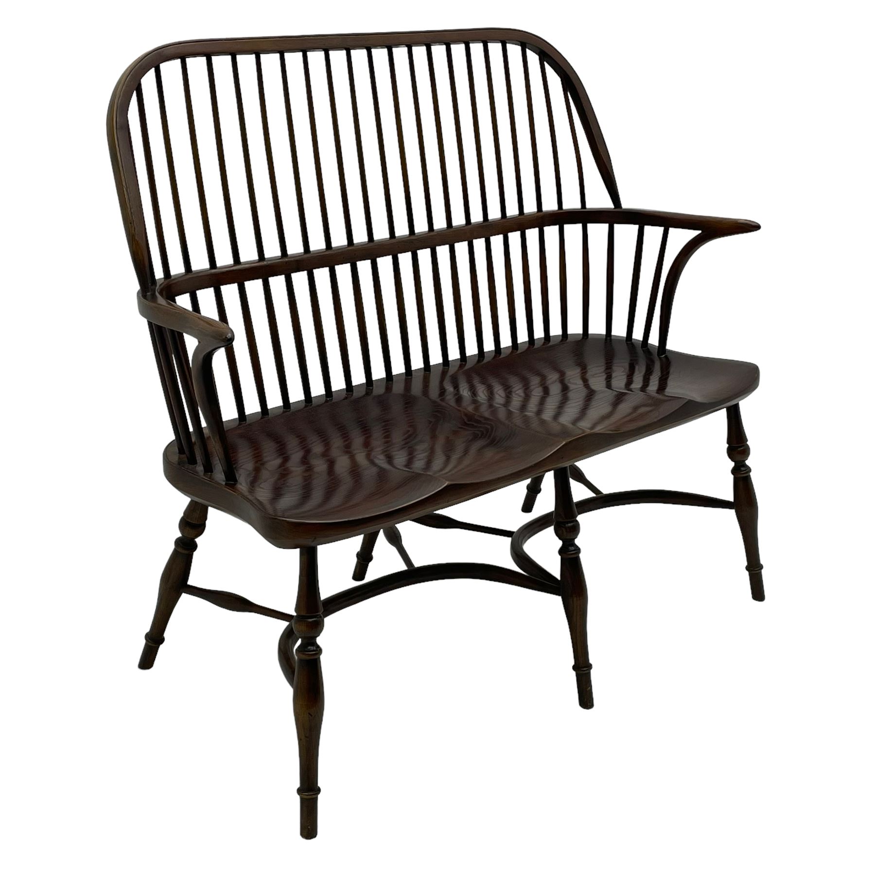 Traditional elm and oak two seat Windsor bench, high comb and stick back, double dished seat on turned supports joined by two crinoline stretchers