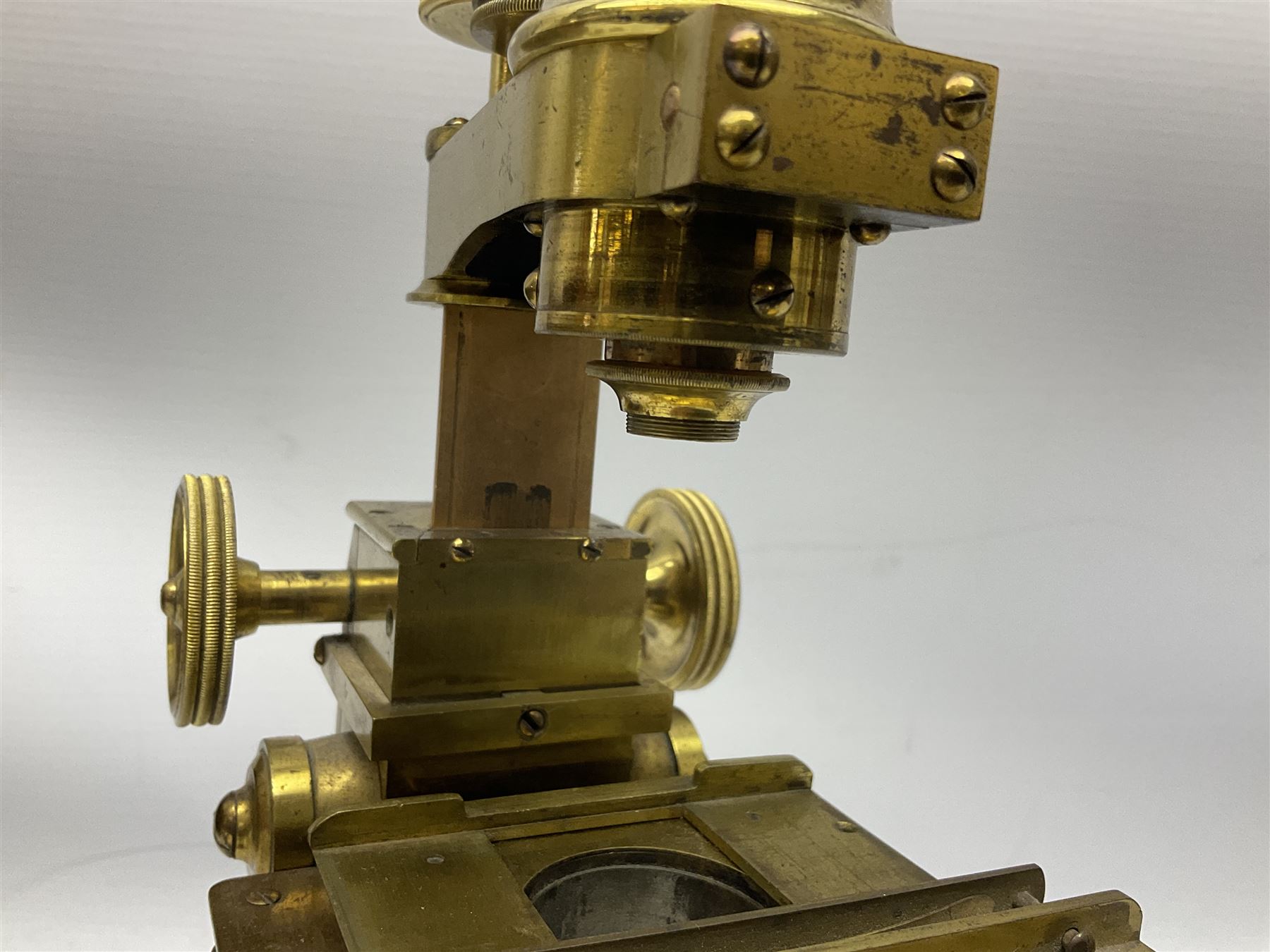 Mid 19th century brass monocular microscope by Andrew Ross, London No.180, with pitchfork base, rack and pinion focusing, revolving bed and swivelling barrel, with accessories, housed in a mahogany case with recessed carry handle and lockable doors