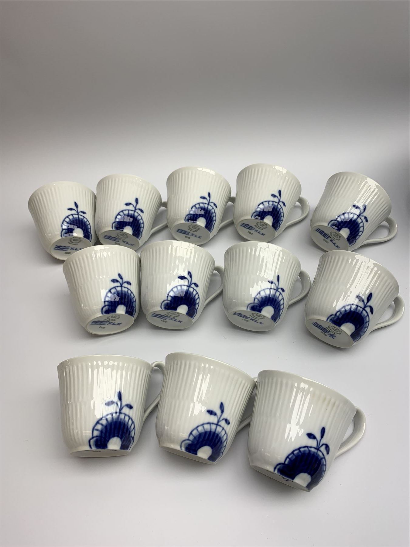 Royal Copenhagen tea and dinner service for twelve place settings, decorated in the Mega Blue Fluted pattern, pattern number 622, comprising dinner plates, salad plates, bowls with pierced rim, smaller bowls, tea cups, and saucers, dinner plates D27.5cm, salad plates D22cm