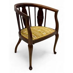 Late Victorian mahogany framed tub chair, rounded backrest with vertical splats and three carved oval medallions, upholstered seat in yellow patterned fabric, on cabriole supports