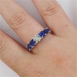 Platinum seven stone diamond and sapphire ring, the principal round brilliant cut diamond of approx 0.70 carat, with three princess cut sapphires set either side, hallmarked, total sapphire weight approx 1.95 carat