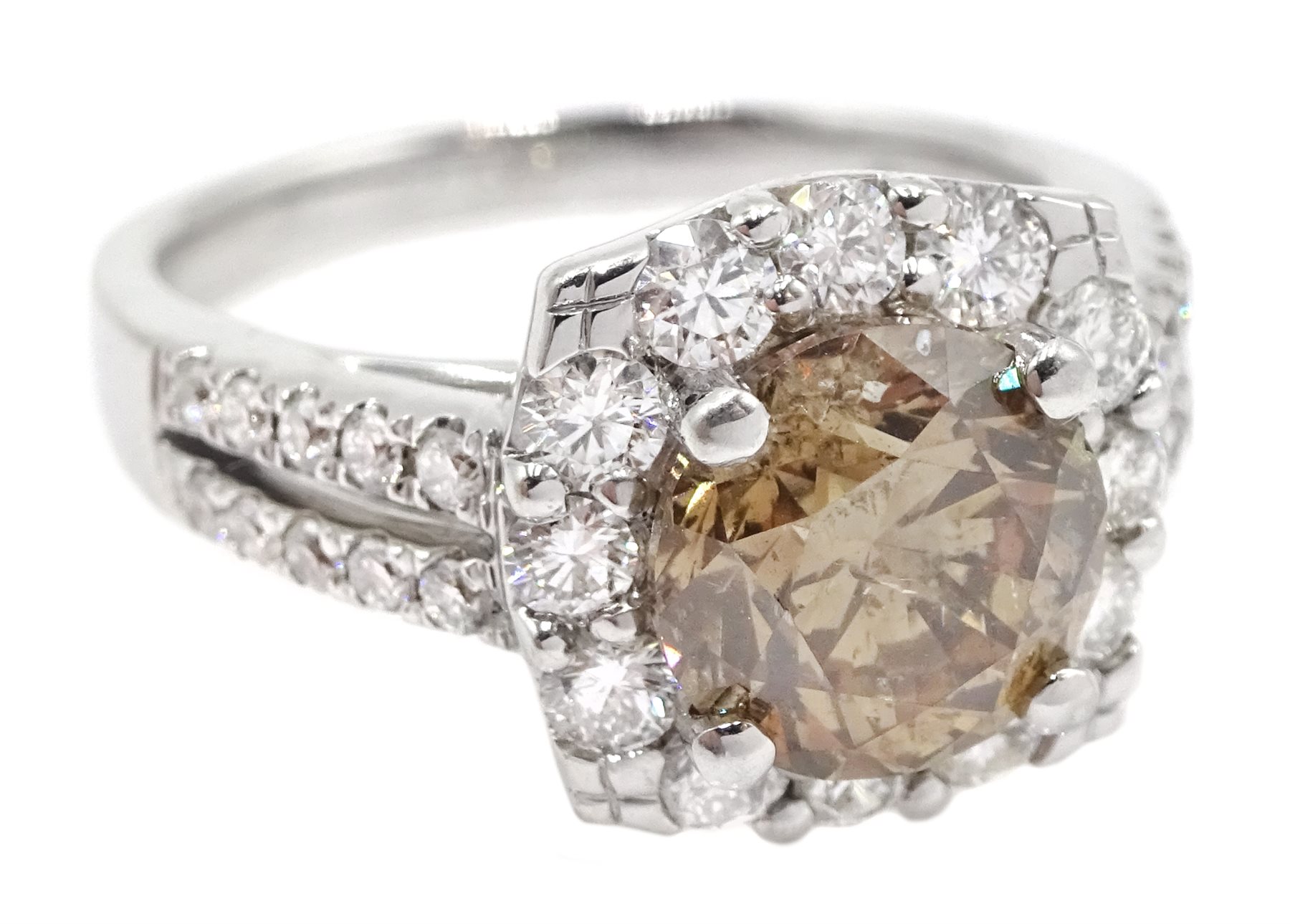 18ct white gold round brilliant cut fancy light brown diamond ring, with halo diamond surround and diamond set shoulders, stamped 750 18K, central diamond 2.00 carat, total white diamond weight 0.90ct