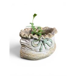 Four cast stone garden planters in the form of ribbon tied planting sacks