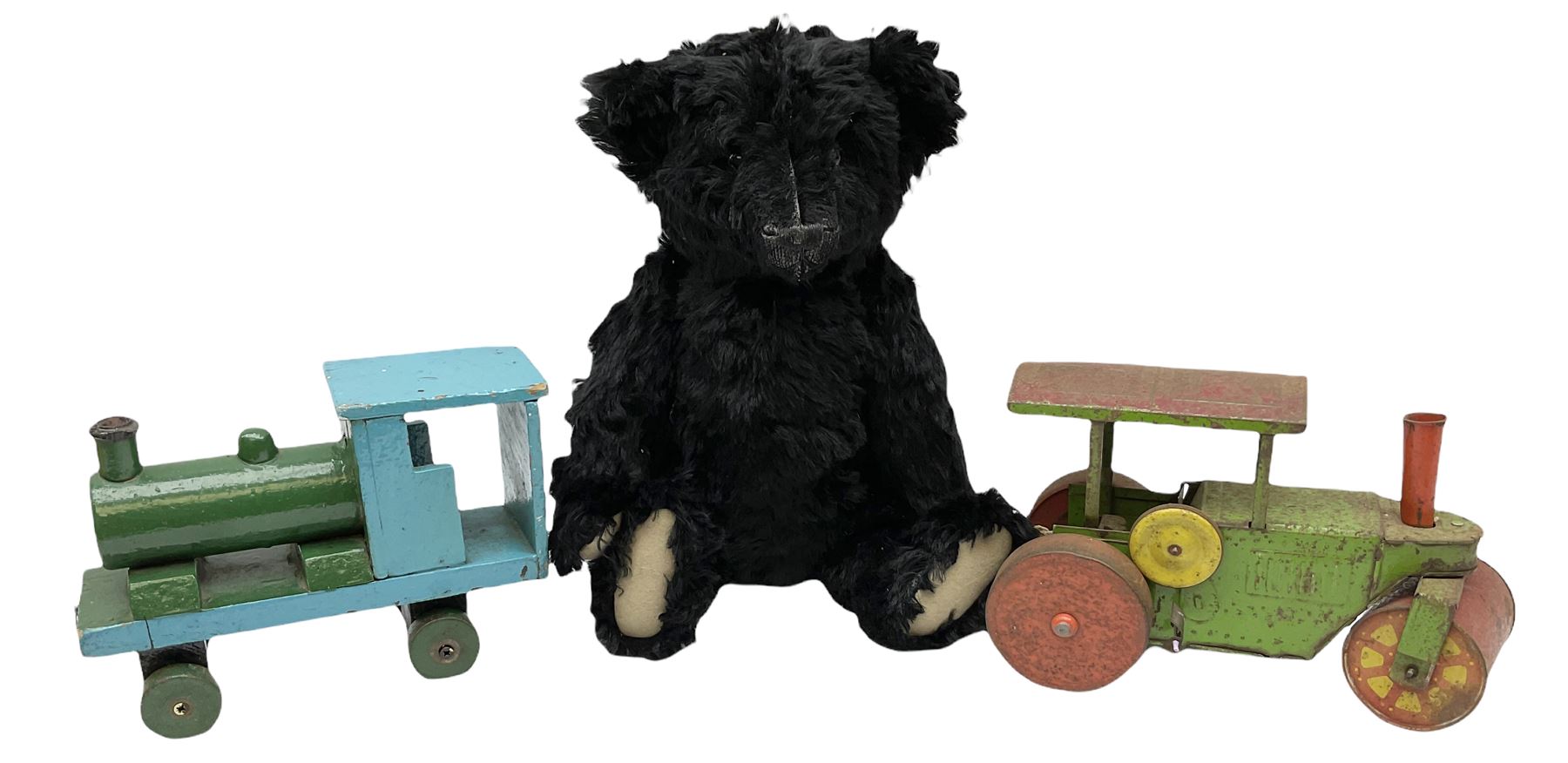 1991 Atlantic Bears limited edition black teddy bear, the revolving head with applied eyes, vertically stitched nose and jointed limbs with growler mechanism No.84/100 H53cm; together with clockwork tin-plate road roller possibly by Mettoy and a push-along painted scratch built wooden locomotive (3)