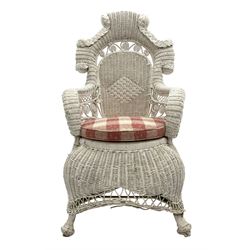 Early 20th century white painted wicker armchair, shaped pediment over a lozenged woven patterned back, the curved arms surmounted on scroll work, circular shaped seat with seat cushion, on waisted bulbous base with splayed supports