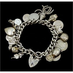 Silver charm bracelet including, Lincoln Imp, shell, teacup and saucer, crown and pekingese