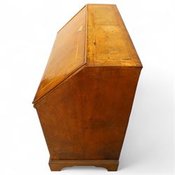 18th century walnut and herringbone banded bureau, the fall front enclosing a stepped and arched interior fitted with pigeonholes, drawers and concealed compartments, green tooled leather writing surface, over two short and three long graduated drawers with brass escutcheons and bail handles, shaped bracket feet