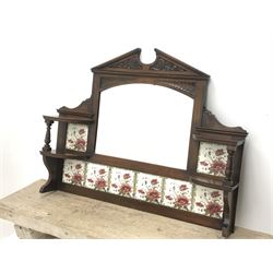 *Late Victorian walnut mirror back, sloped arch pediment carved with scrolled acanthus leaves above arched bevelled mirror, set with floral tiles, W104cm, H80cm