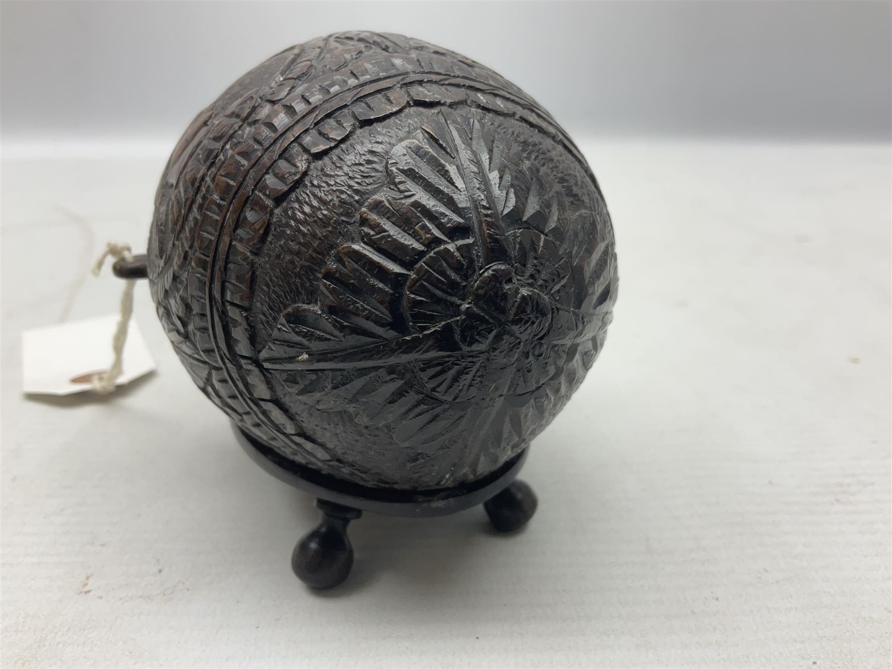 19th century bug bear flask carved with Balkan figures, a wolf and leafage with glass eyes, L14cm on stand 