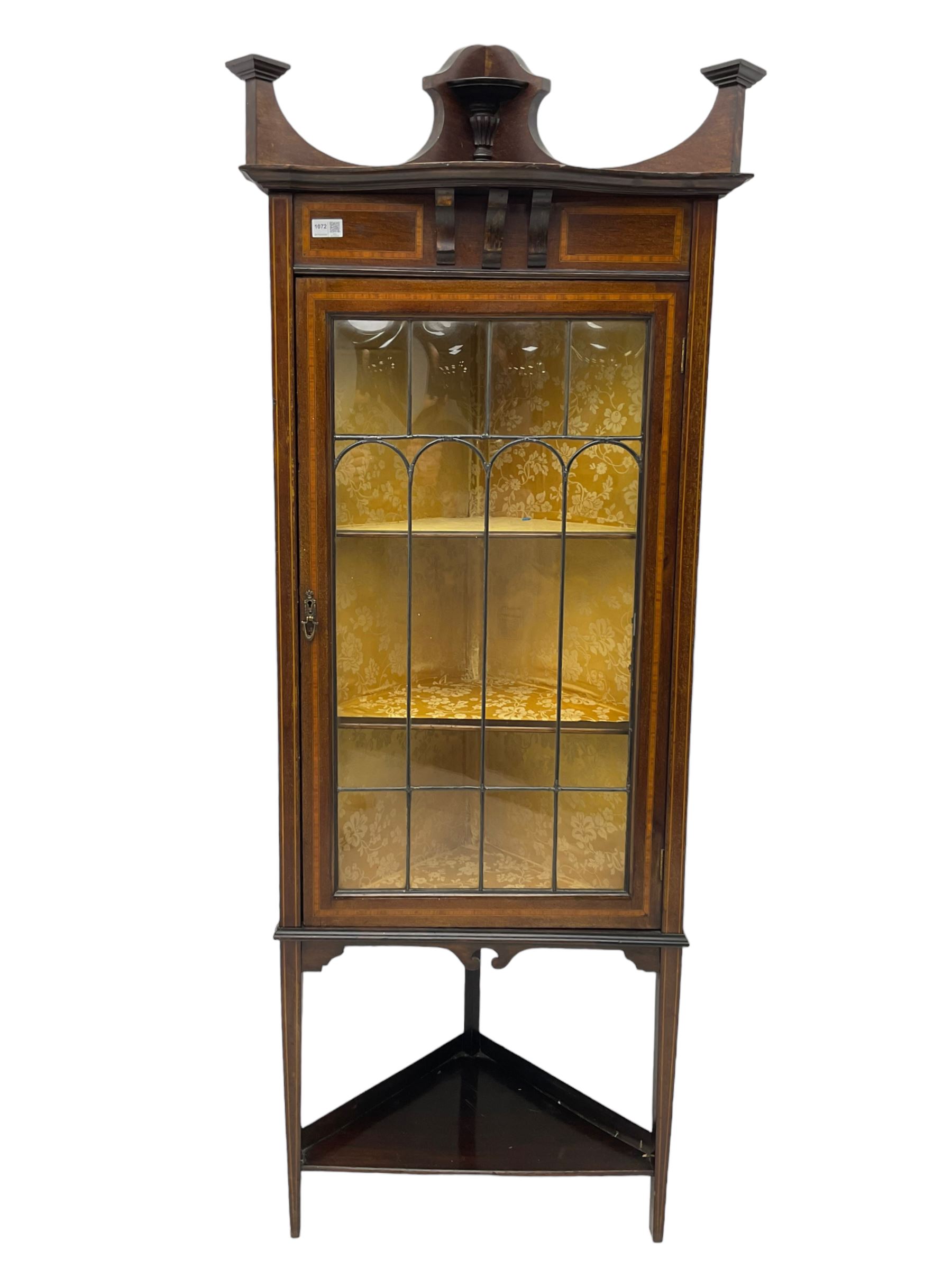 Edwardian inlaid mahogany corner cabinet, fitted with single astragal glazed door enclosing two shelves, flanked by satinwood banding, on square tapering supports united by undertier