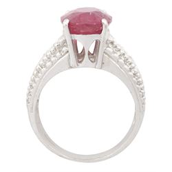 18ct white gold ruby and diamond ring, single oval cut ruby of approx 5.05 carat, with three round brilliant cut diamonds to each shoulder, Birmingham 2006