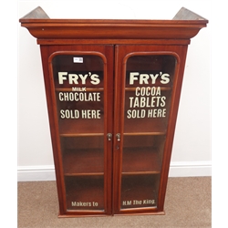  Early 20th century mahogany display cabinet, projecting cornice, two arched glazed doors with 'FRY'S MILK CHOCOLATE' painted on, enclosing three adjustable shelves, W72cm, H113cm, D36cm  