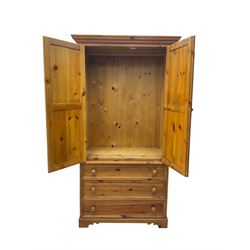 Solid waxed pine double wardrobe, two panelled doors enclosing hanging rail, base fitted with three drawers