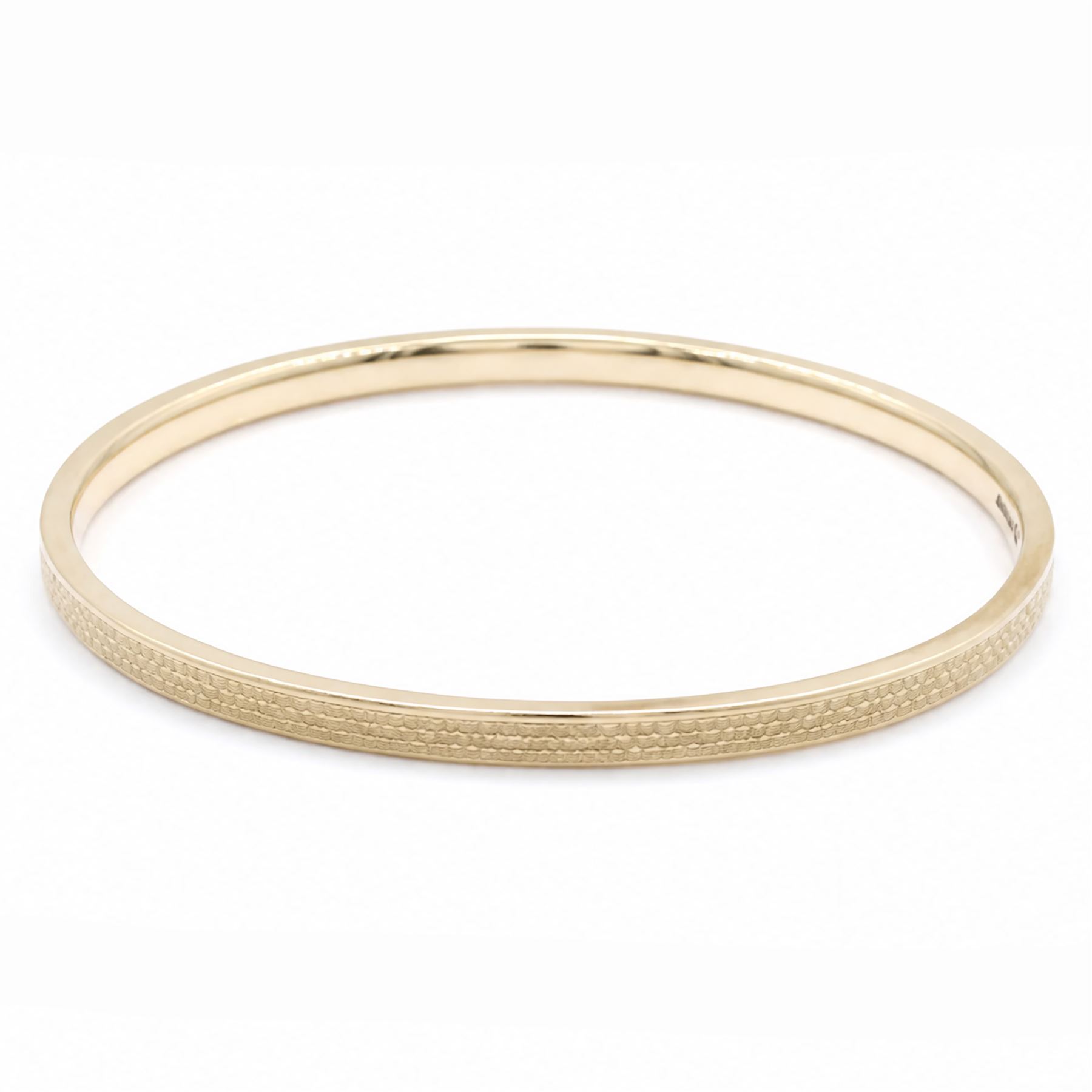 Early 20th century 9ct gold arm bangle, with engine turned decoration by Deakin & Francis Ltd, Birmingham 1922