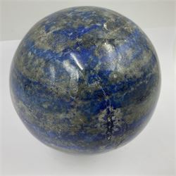 Lapis lazuli sphere upon a carved wooden base 