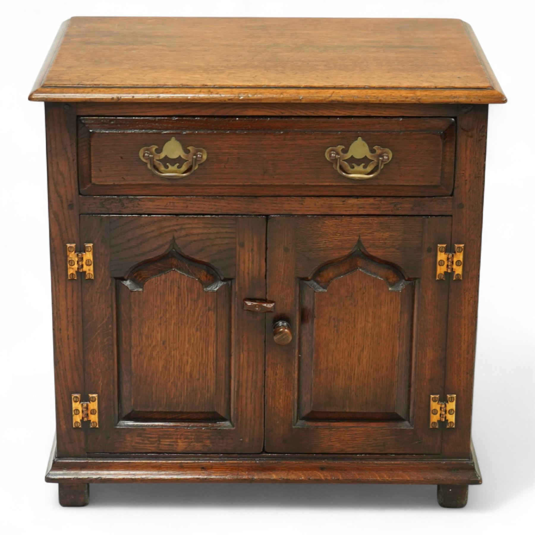 Titchmarsh & Goodwin - small oak side cupboard, moulded rectangular top over single drawer and double cupboard, stepped and pointed arched panelled doors, raised on stile feet 