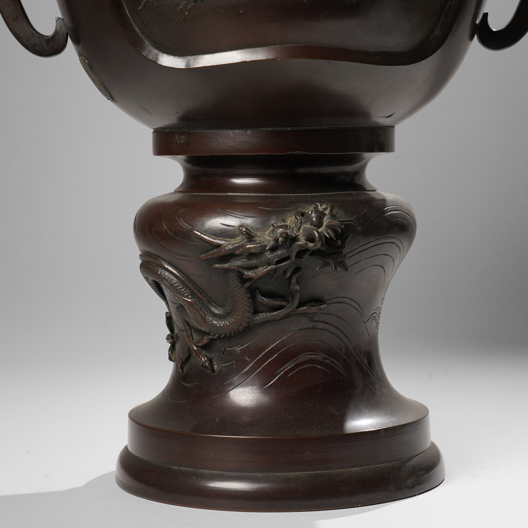 Japanese late Meiji period bronze koro and cover, surmounted by an eagle finial and with bird decoration in high relief to each side, twin elephant trunk handles, bearing indistinct character signature to one side, H82cm