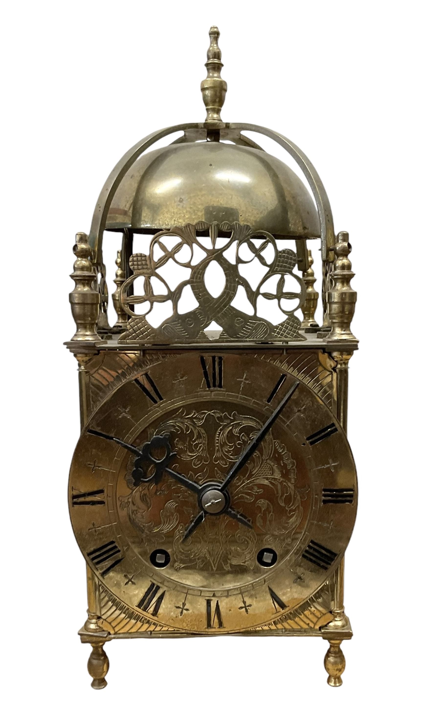 English - 20th century 8-day lantern clock in period 18th century style, square brass case surmounted by a domed bell, with a brass chapter, engraved dial centre and stylised period steel hands, with a two train spring driven movement striking the hours and half hours on a bell. With pendulum. 