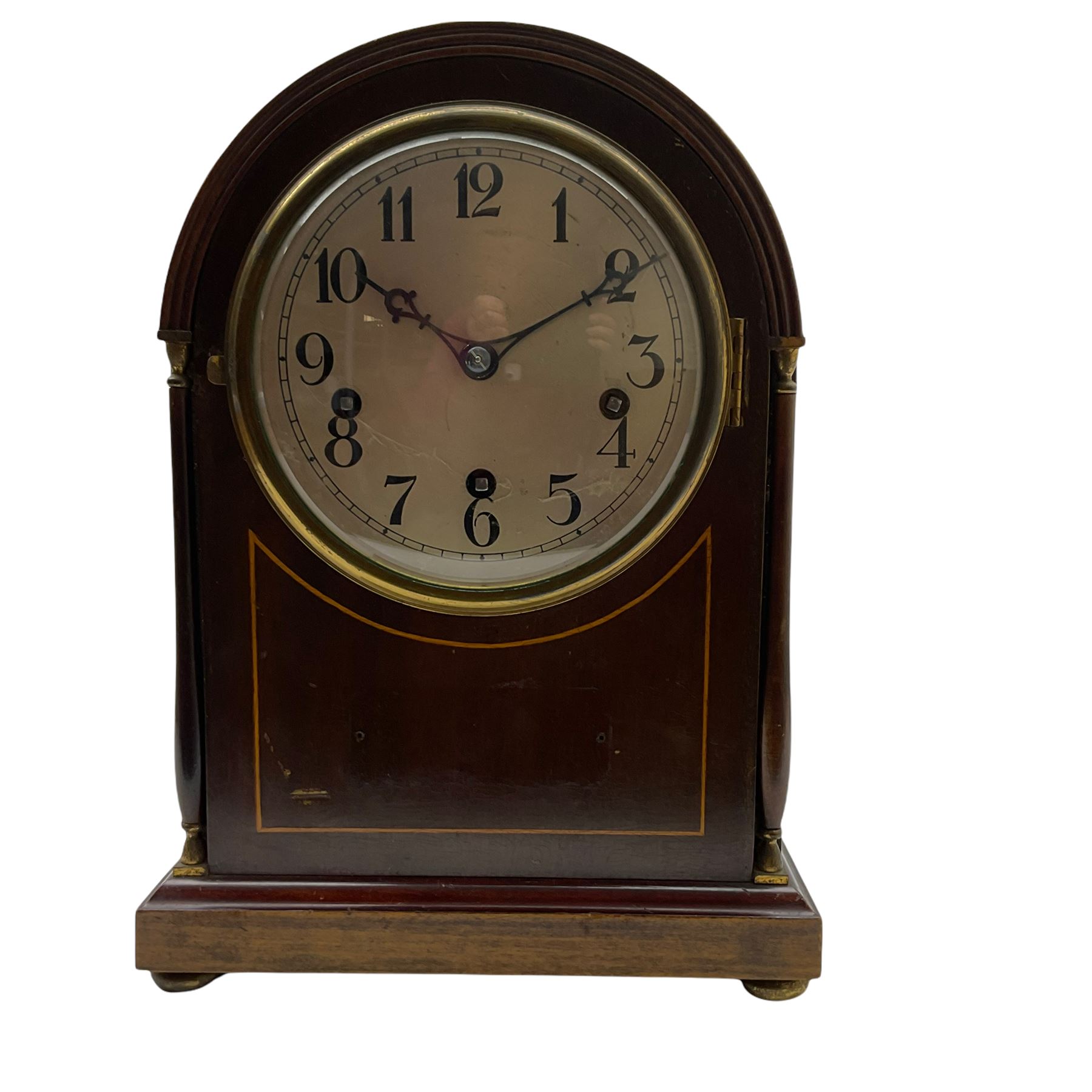 An early 20th century arch topped mahogany mantle clock with inlaid