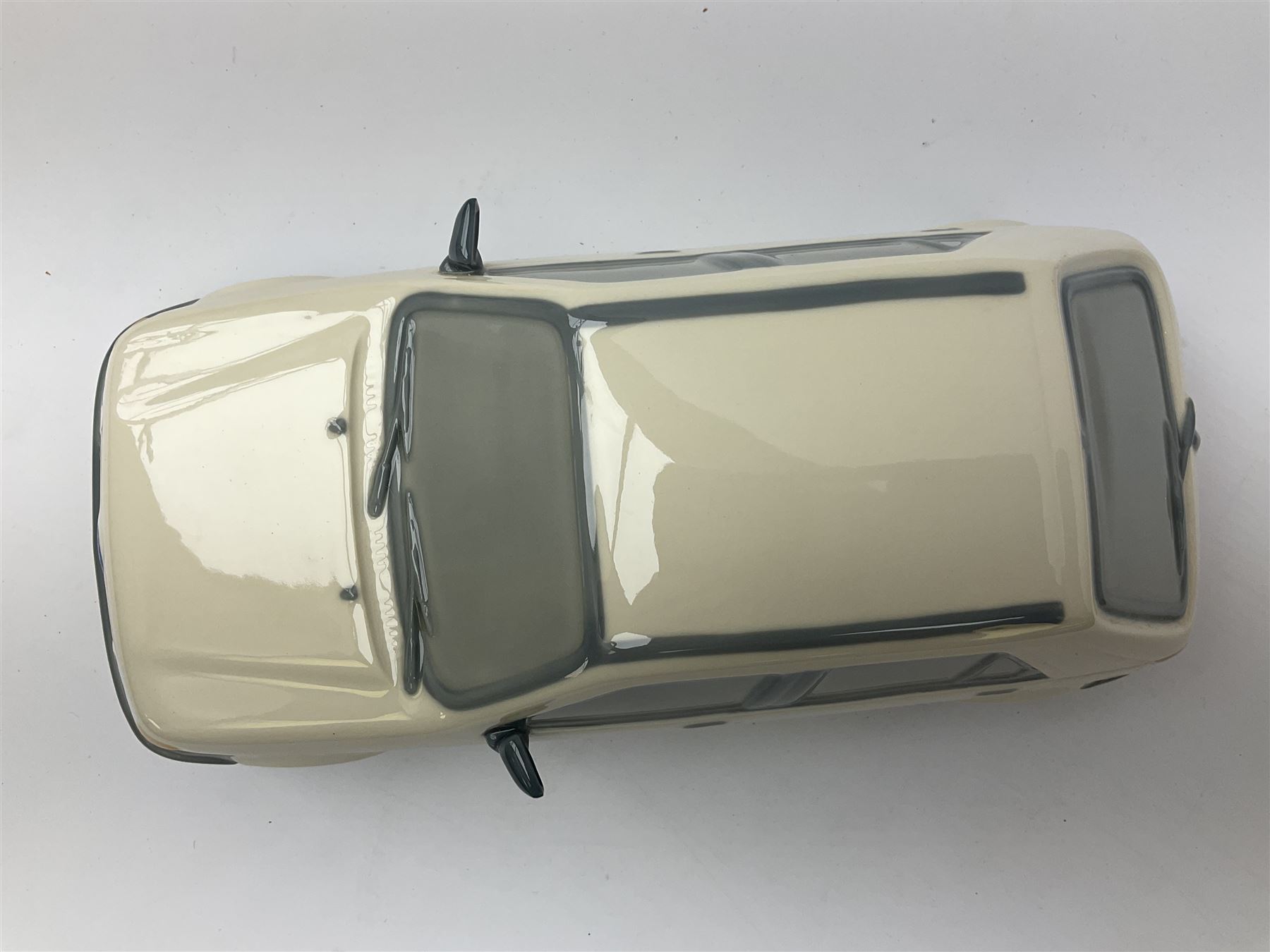 Lladro figure, Ford Fiesta, modelled as a Ford in beige, special commission by the Ford factory in Valencia, original box, no 7608, year issued 1989, year retired 1989, H9cm 