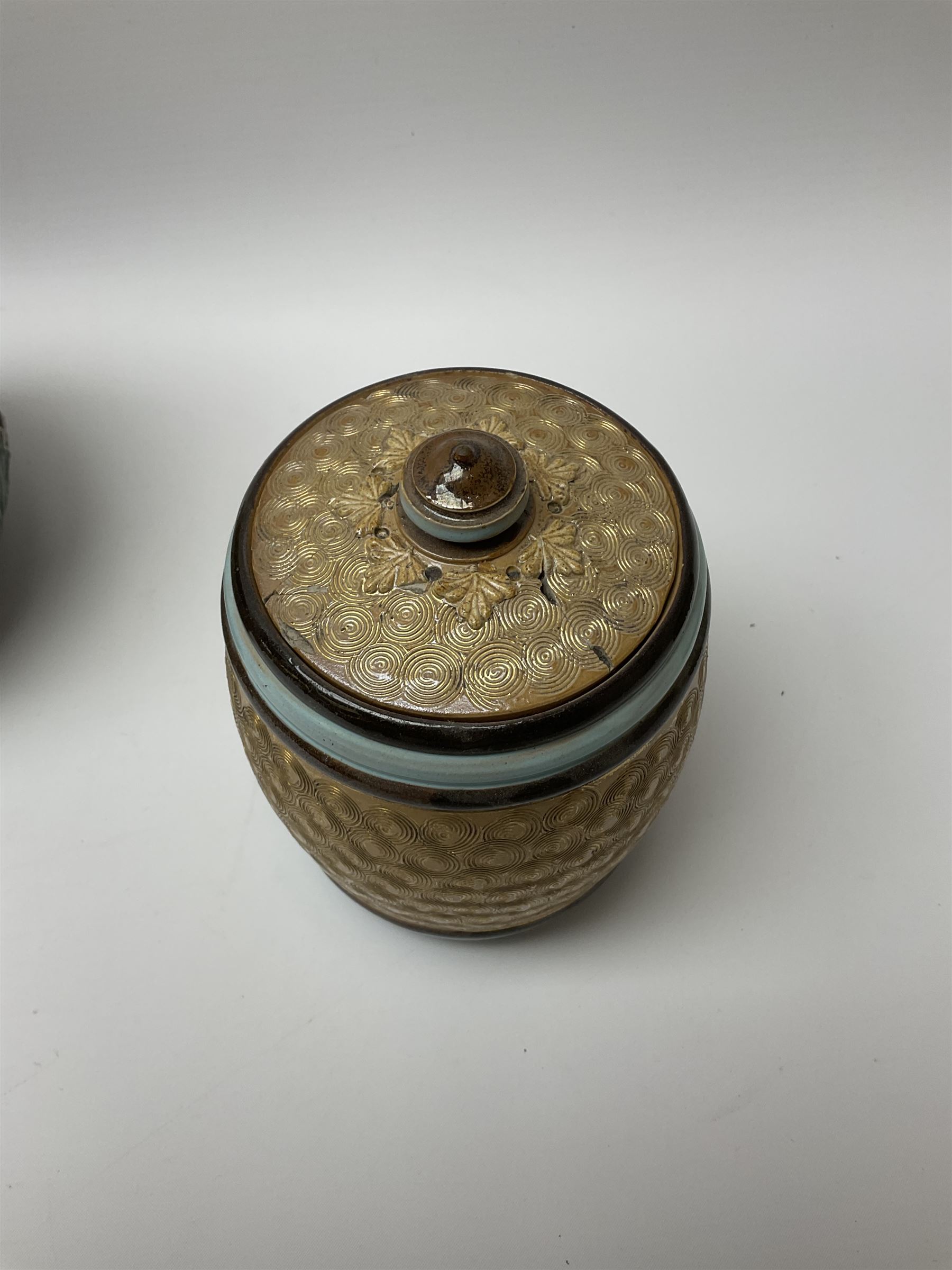 A group of Doulton Lambeth and Royal Doulton tobacco jars, to include examples with relief moulded foliate decoration, each with impressed marks and markers monograms beneath. 
