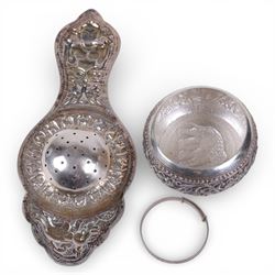 Sri Lankan silver tea strainer and bowl, embossed with elephant decoration and a silver ch...