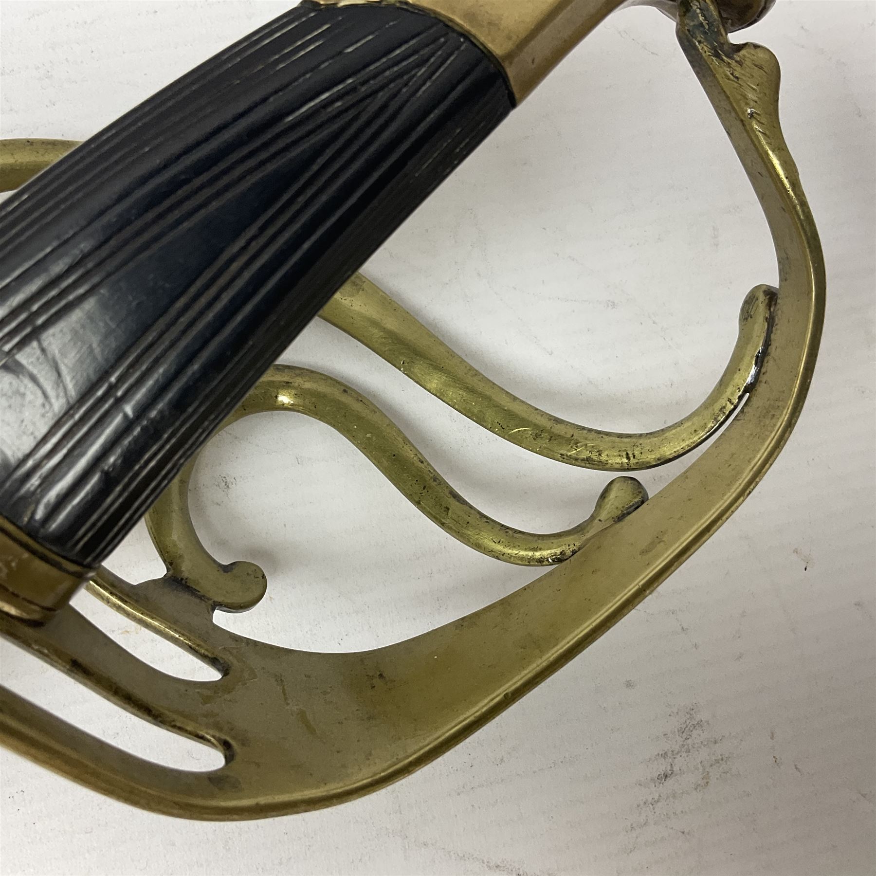 Late 18th century sword, the Spanish 79.5cm curving fullered blade engraved with the Royal Cypher, battle trophies and 'Viva Espania' banner, French Sabre de Mineur brass three-bar hilt with ebonised reeded grip L93.5cm overall (no scabbard)