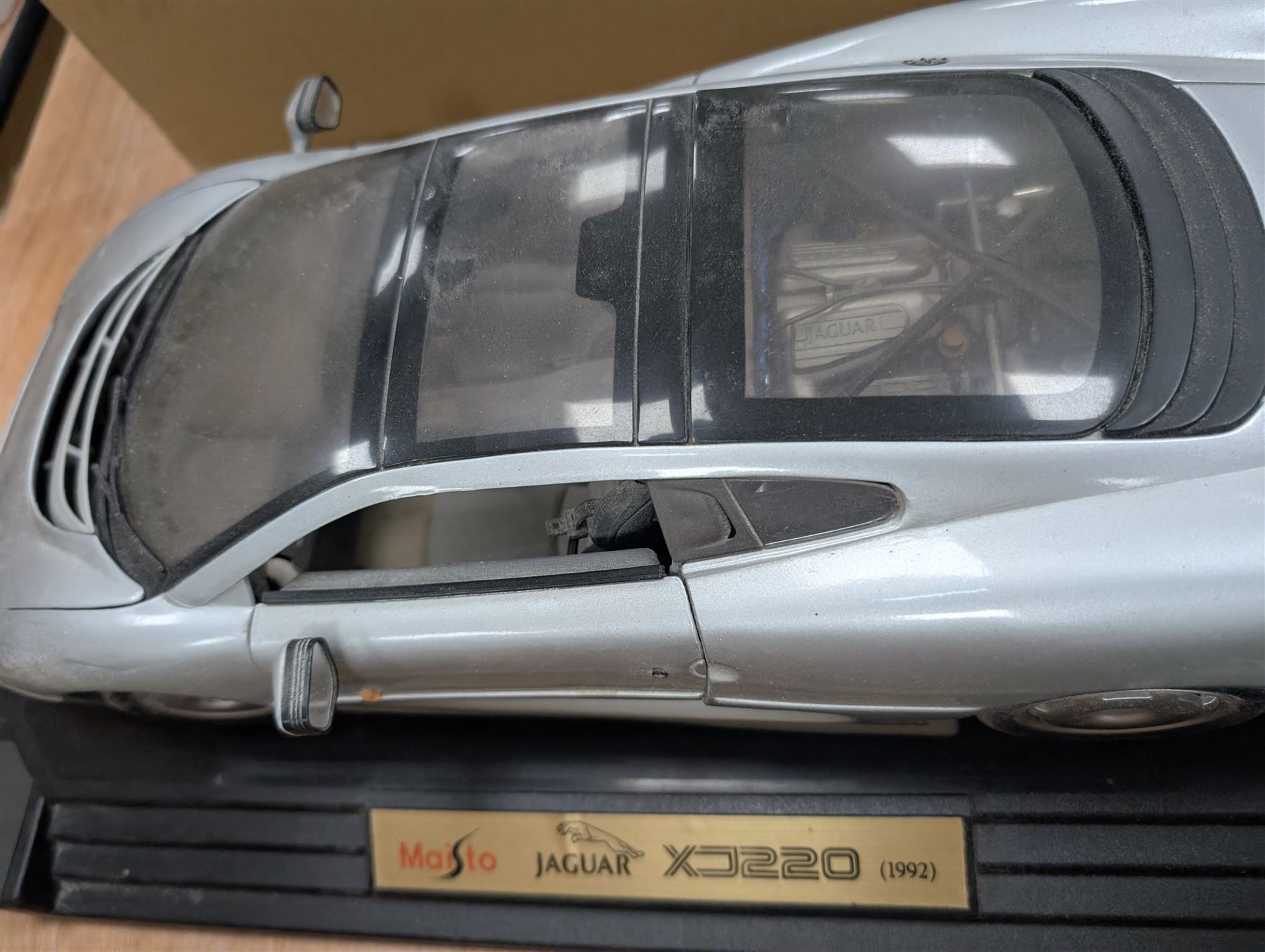 Maisto Jaguar XJ220 model car on stand and a collection of diecast model vehicles, including Vanguards, Unigate and Lledo examples