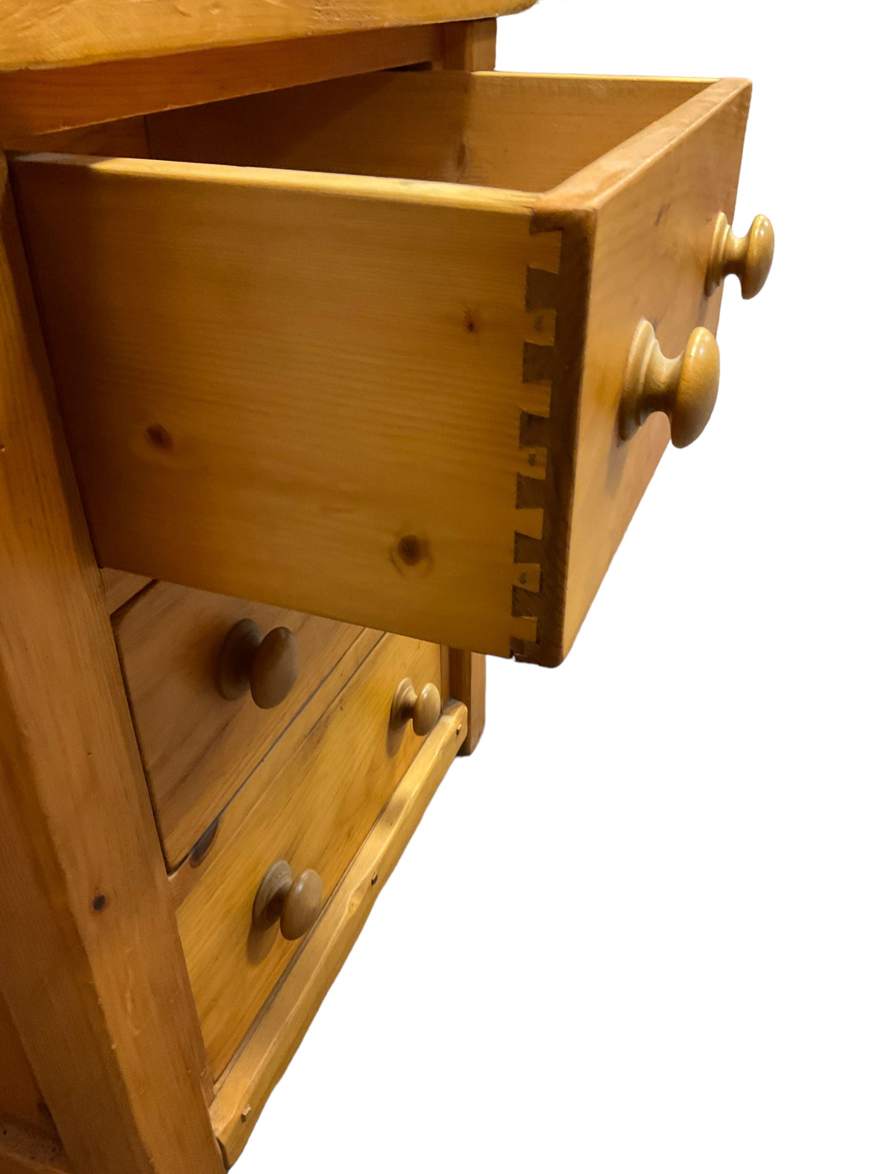 Large pine desk, rectangular top over four drawers, slide and panelled cupboard