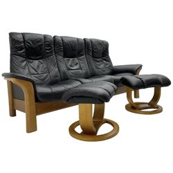 Stressless - 'Buckingham' three-seat settee upholstered in black leather; together with two associated footstools 